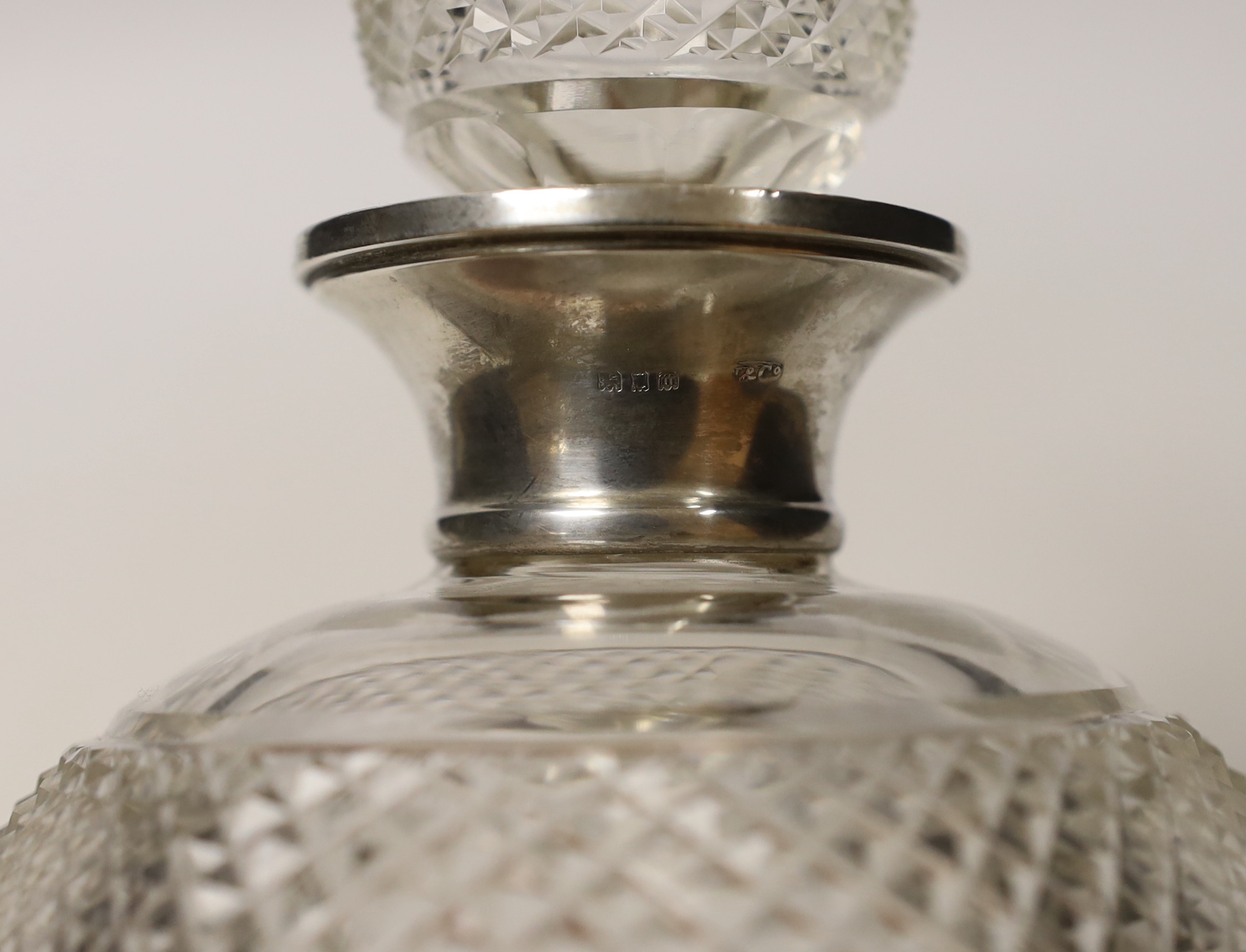 A George V silver mounted cut glass thistle shaped decanter and stopper, Wolfsky & Co Ltd, London, 1927, 29.5cm.